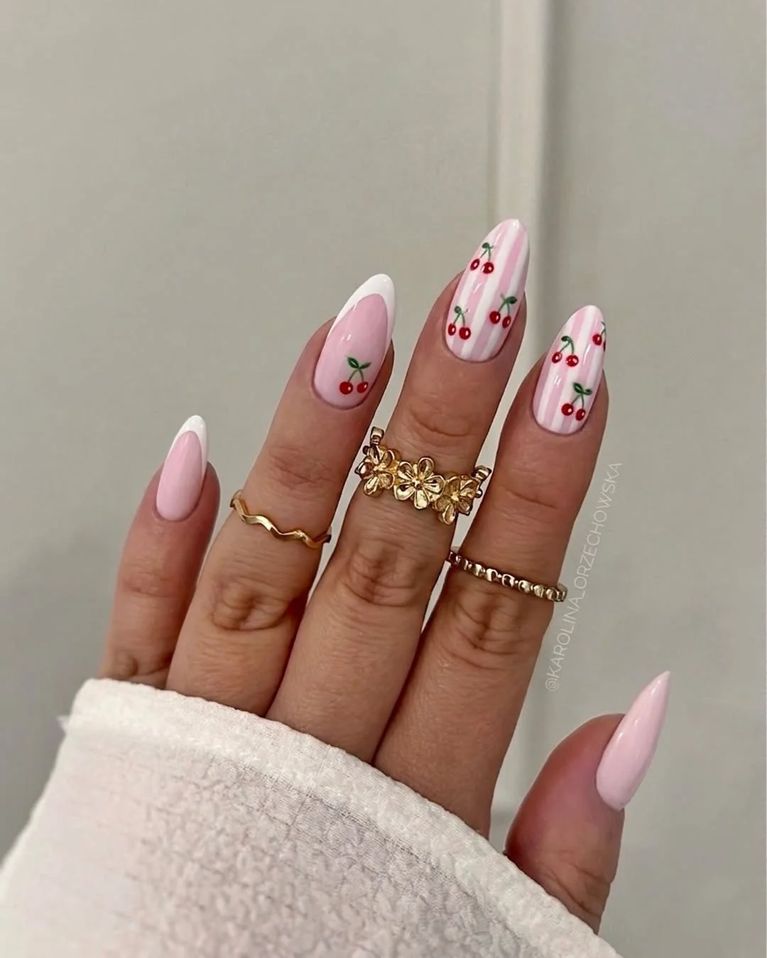 Almond nails with white French tips and red cherry art