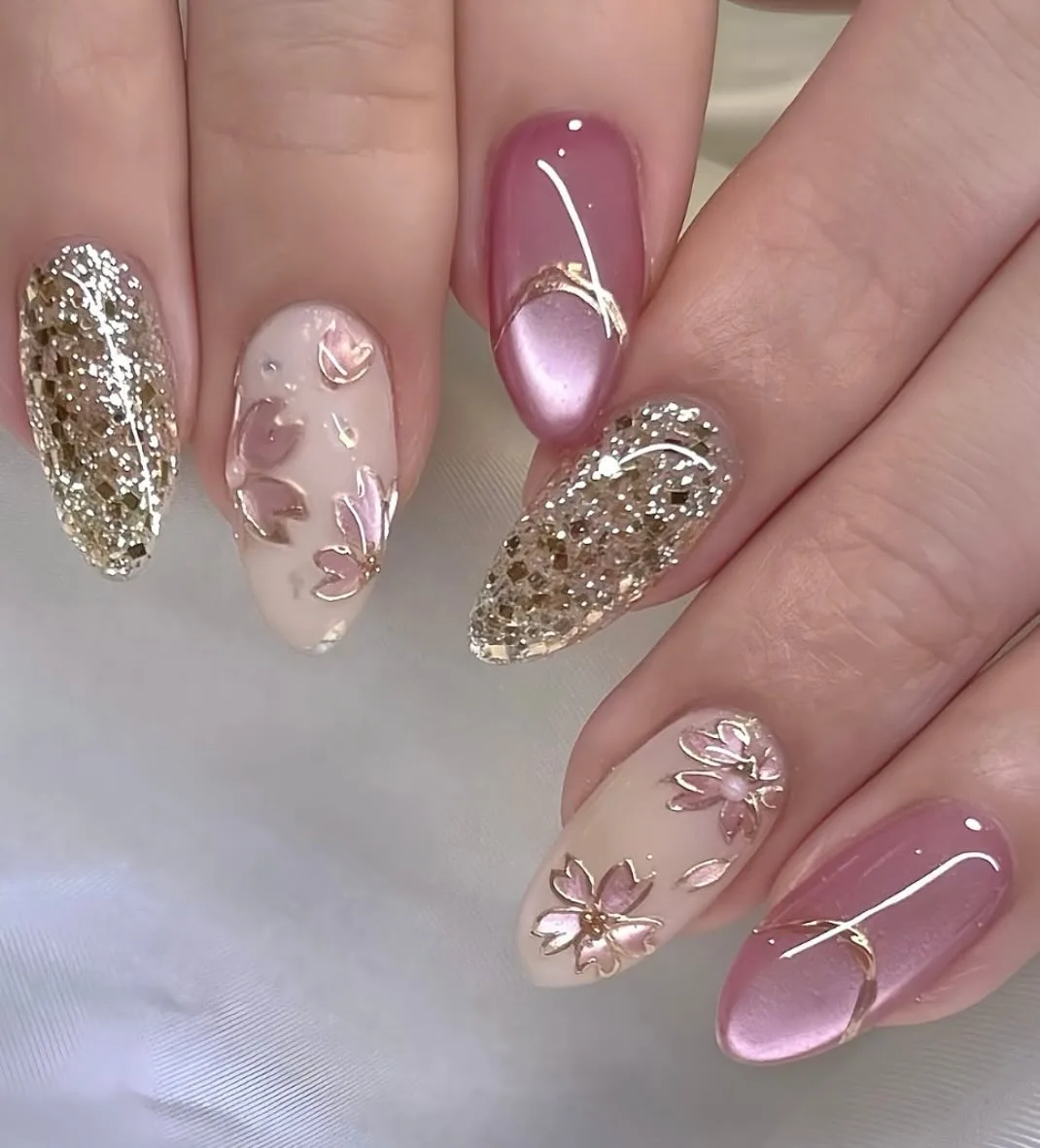 Almond nails with gold glitter and pink chrome accent nails