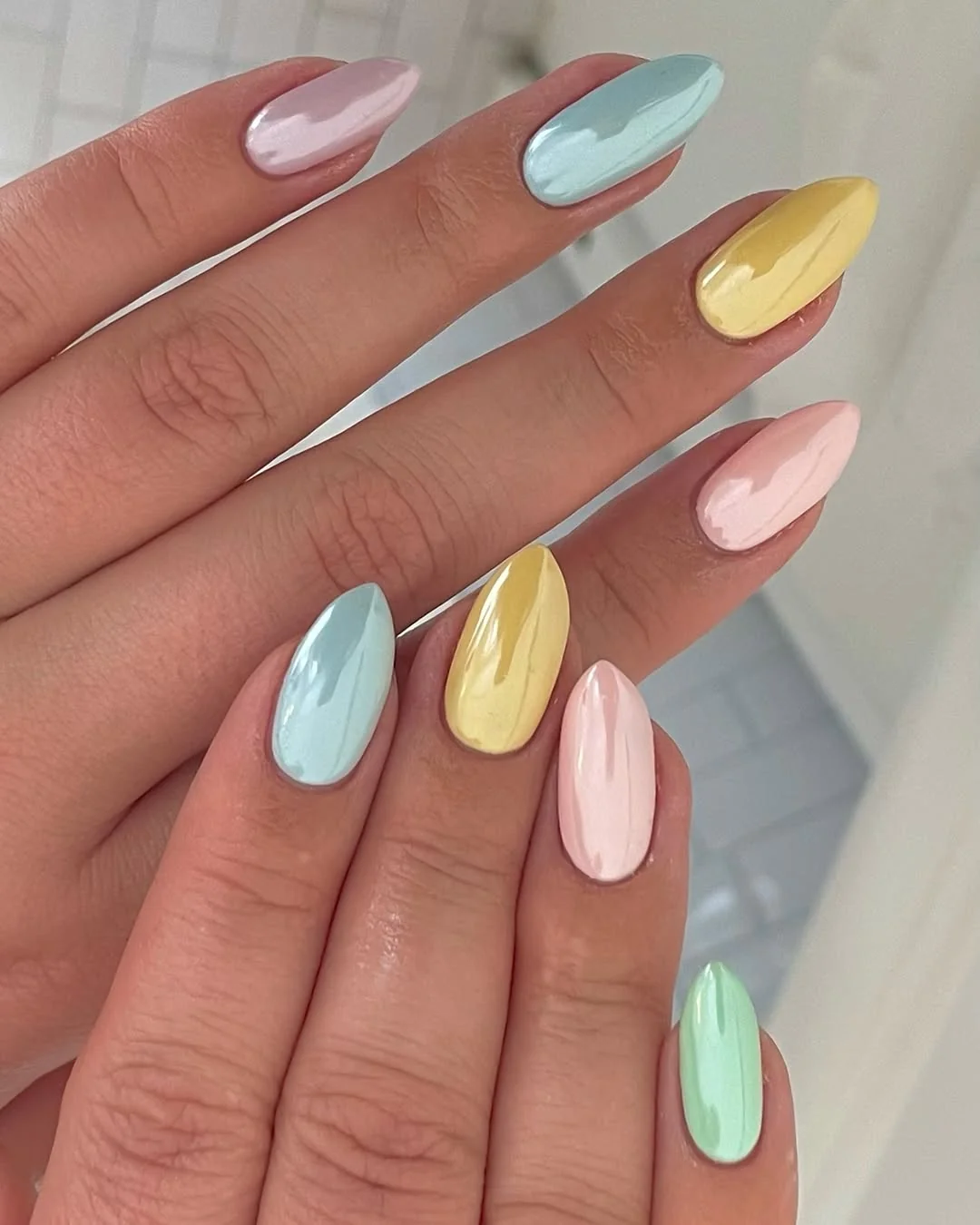 Pastel macaron almond nails in blue, yellow, pink and mint