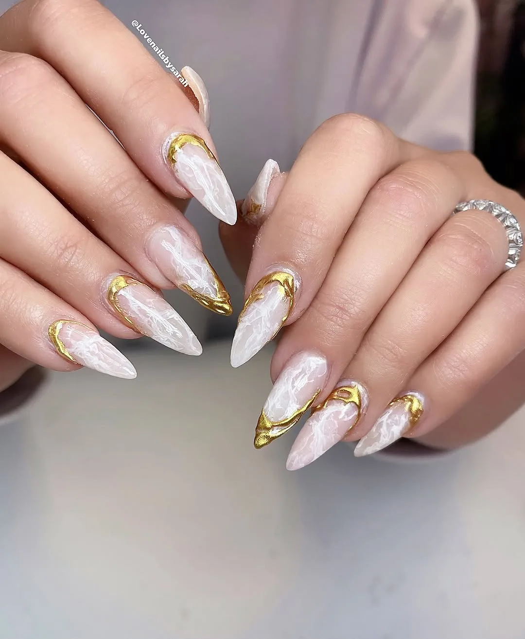 White and nude almond nails with thin gold line art
