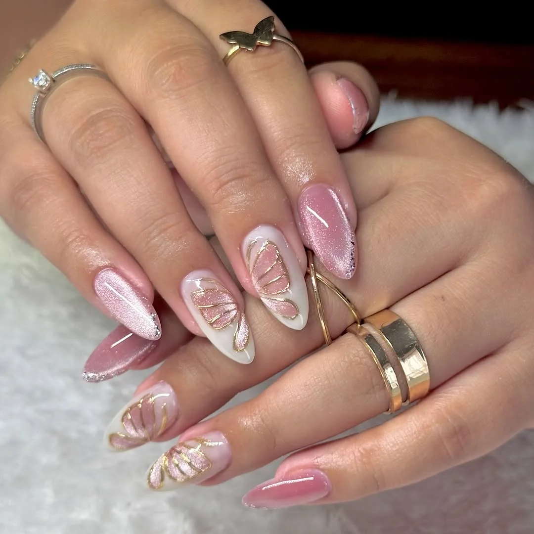 Soft pink cat-eye almond nails with white butterfly wing art