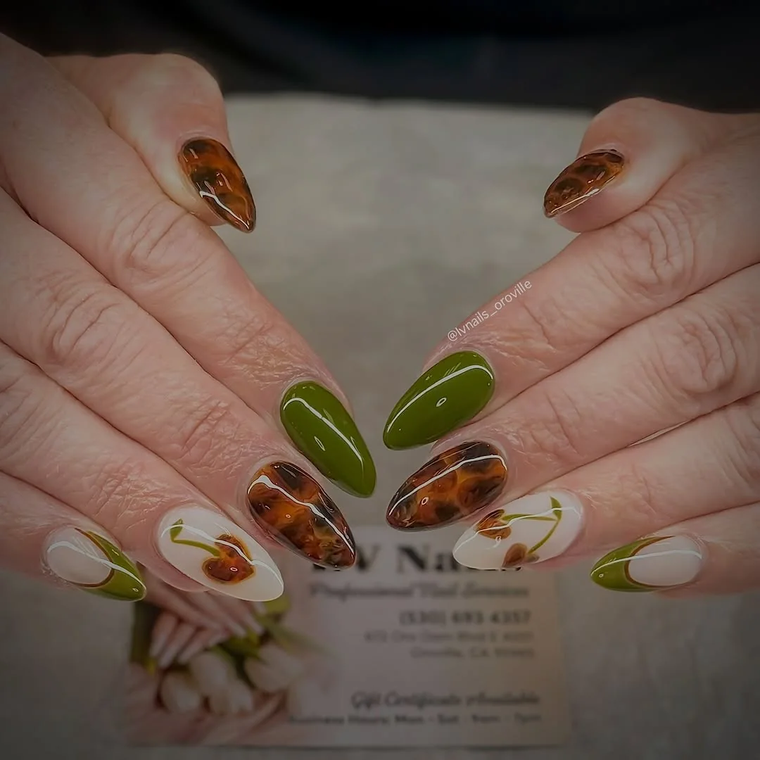 Olive green and tortoiseshell almond nails with floral accent nails