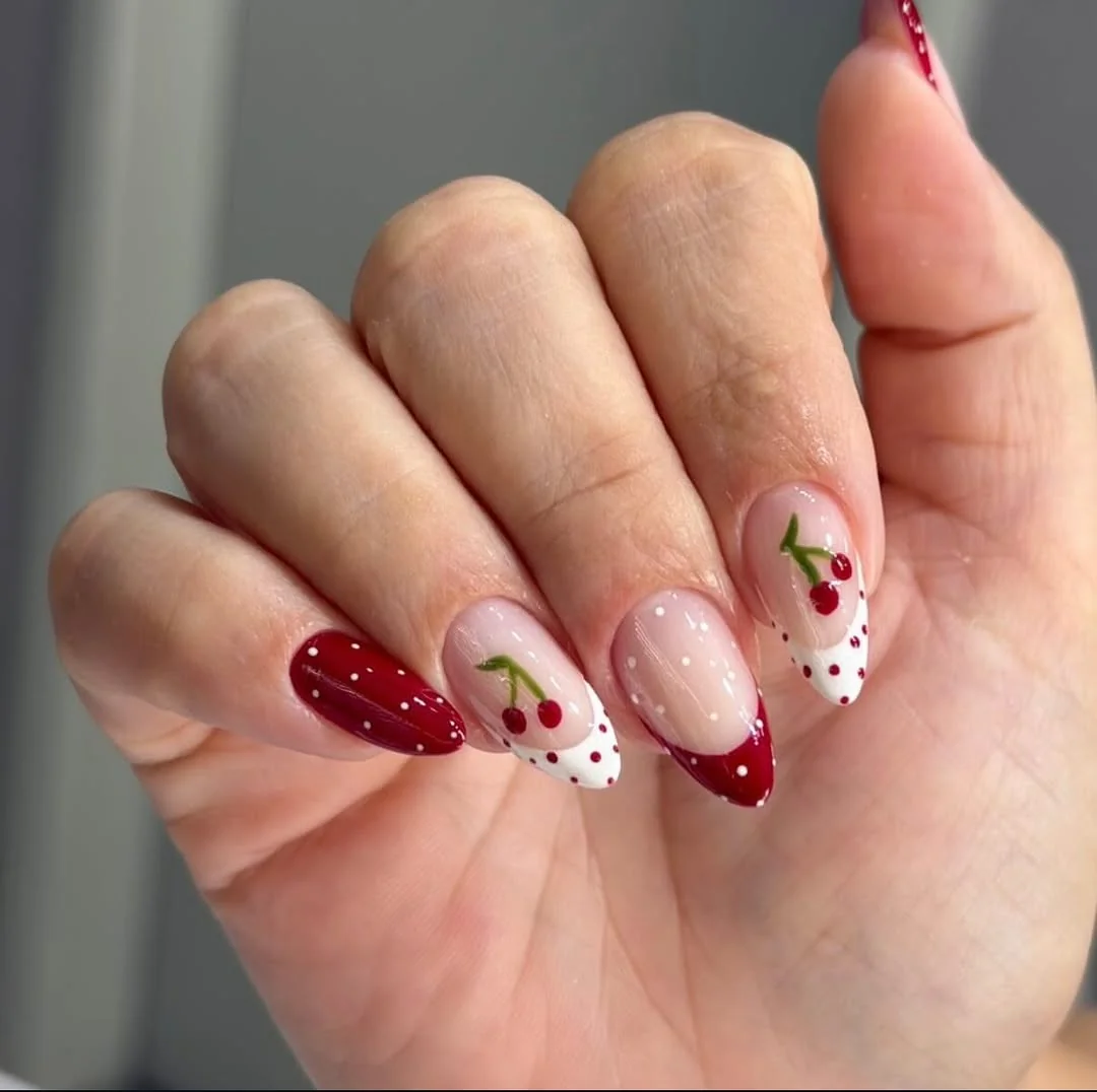 Burgundy and white polka dot almond nails with cherry art