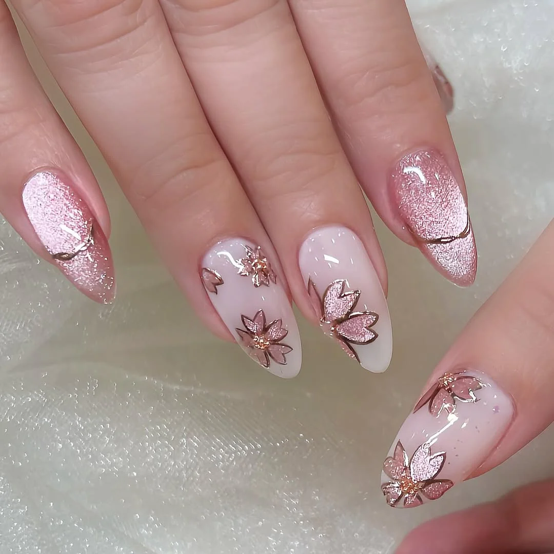 Pink glitter almond nails with minimal blossom line art accents