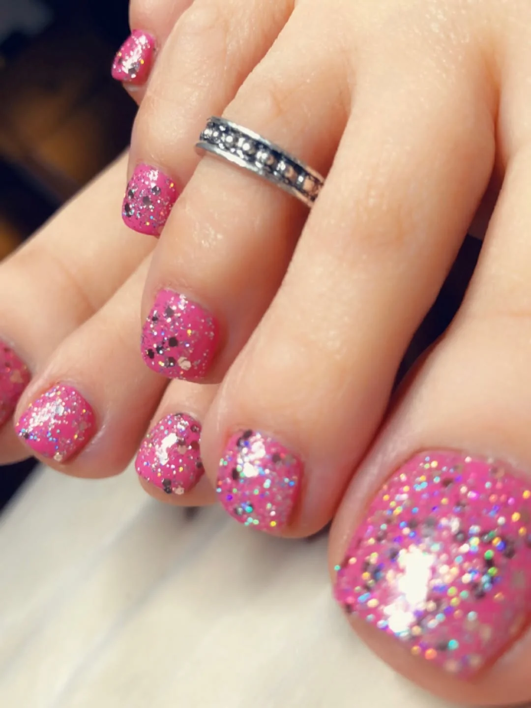 Pink glitter toenails pedicure