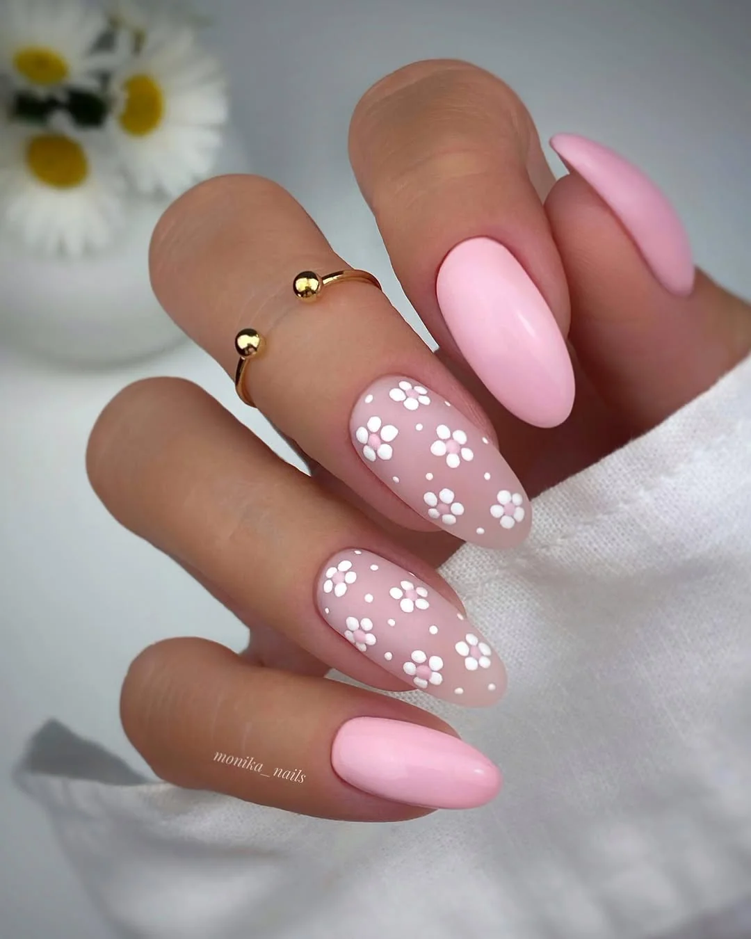 Pink and nude almond nails with white daisy flower pattern