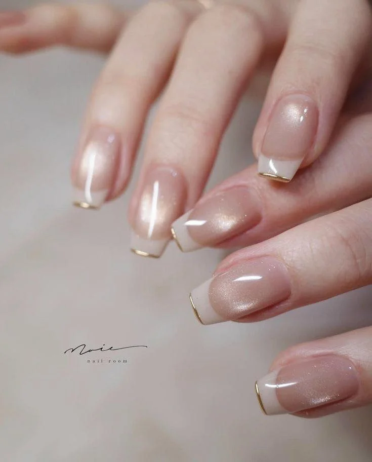 Sheer pink bridal cat-eye nails with gold French edging