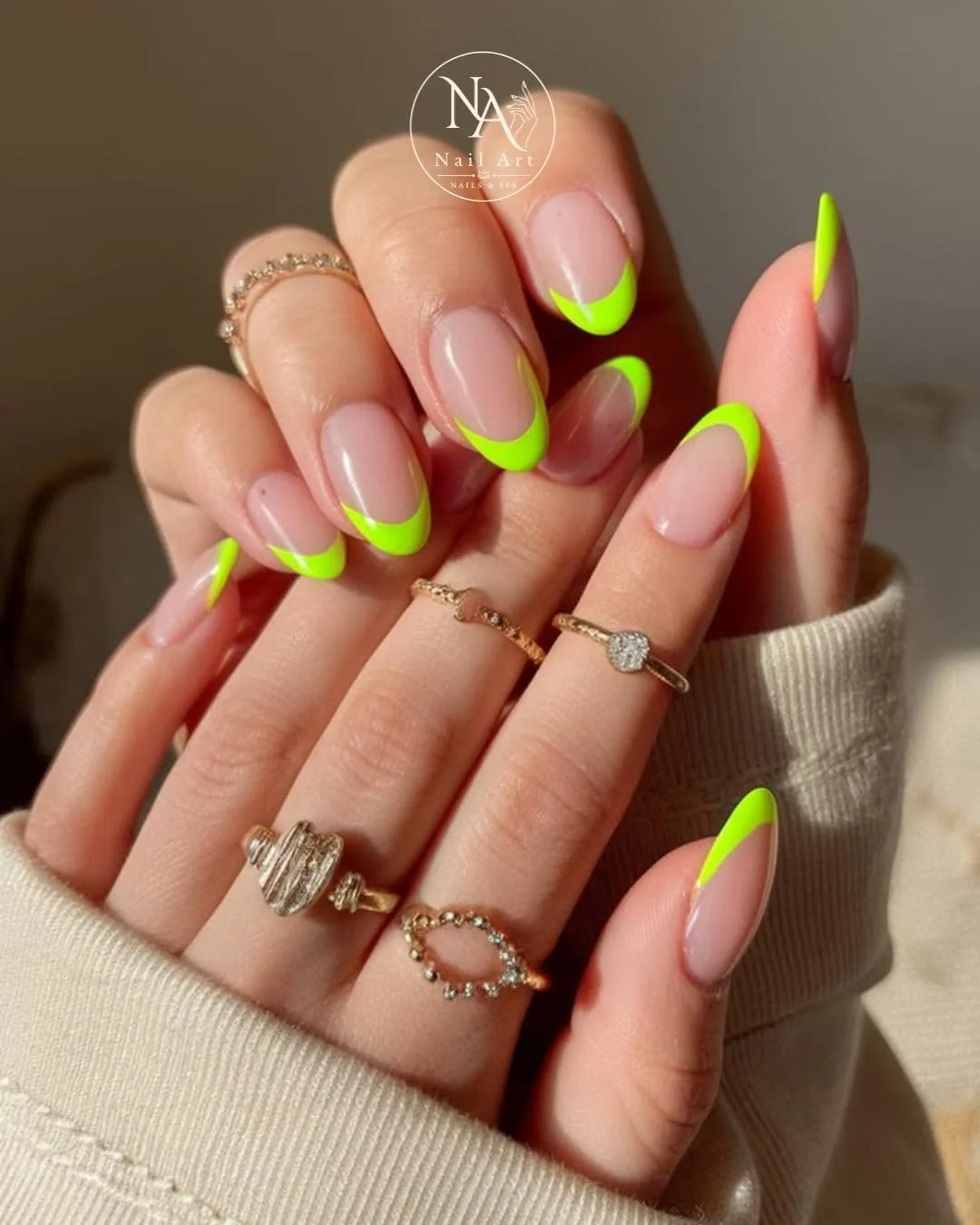 Nude almond nails with neon green and pink French tips