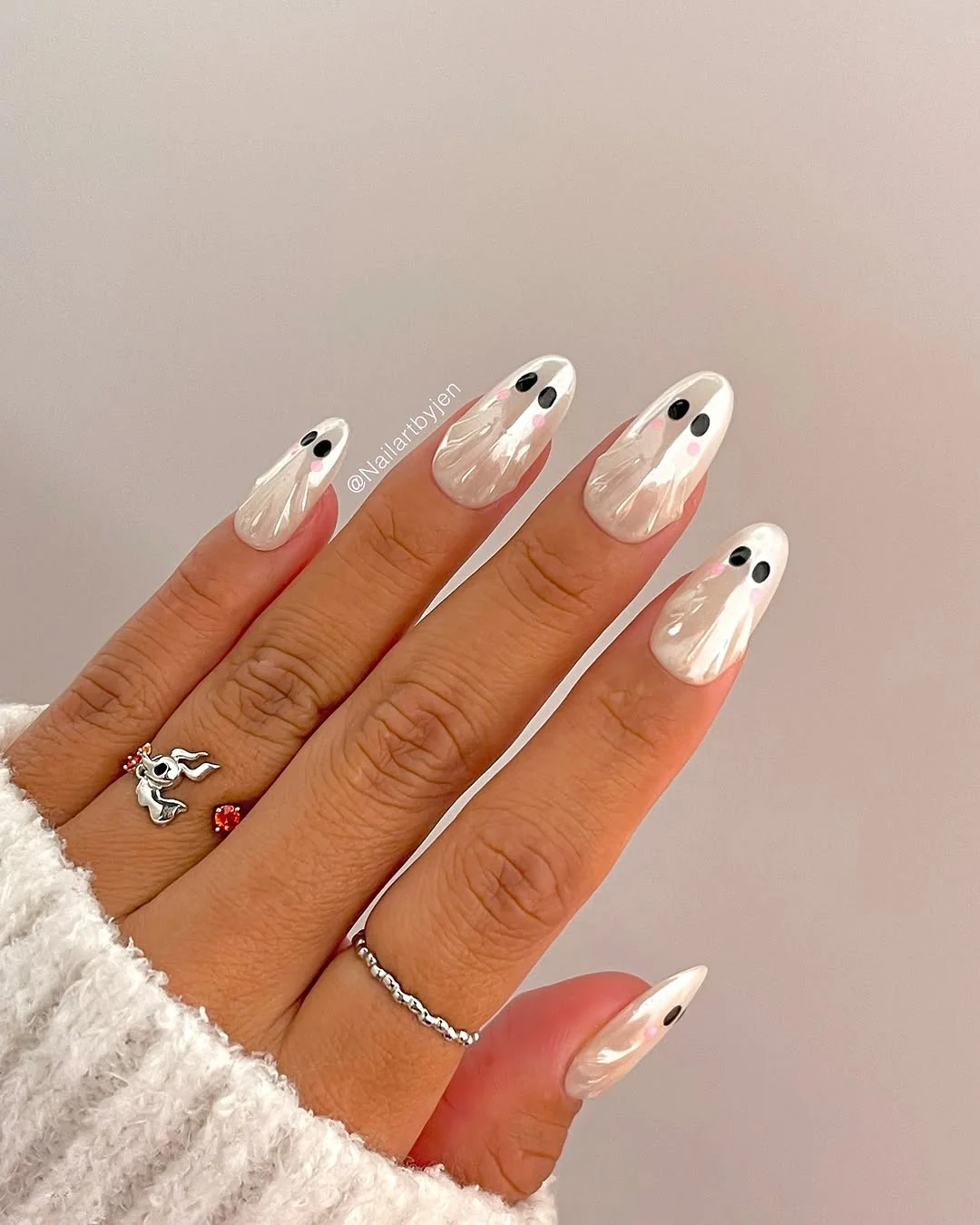 Almond nails with tiny black-eyed ghost French tips