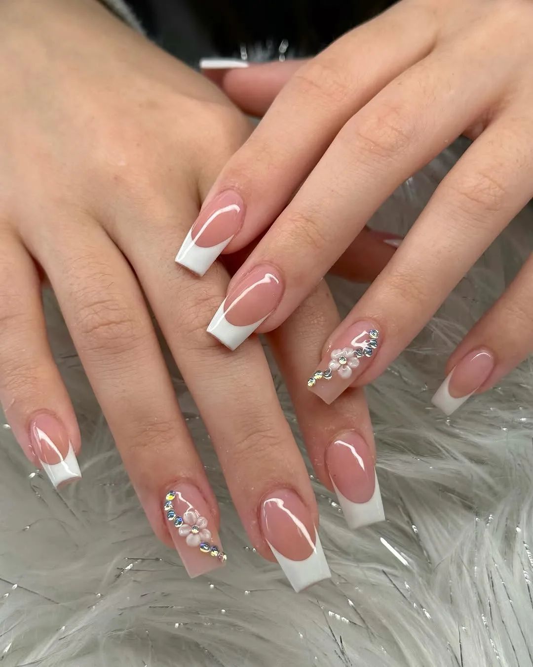 Pink French tip nails with white tips and crystals