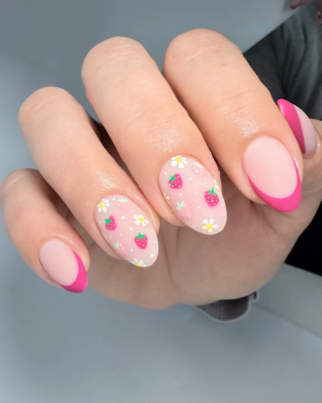 Pink almond nails with strawberry art and hot pink French tips