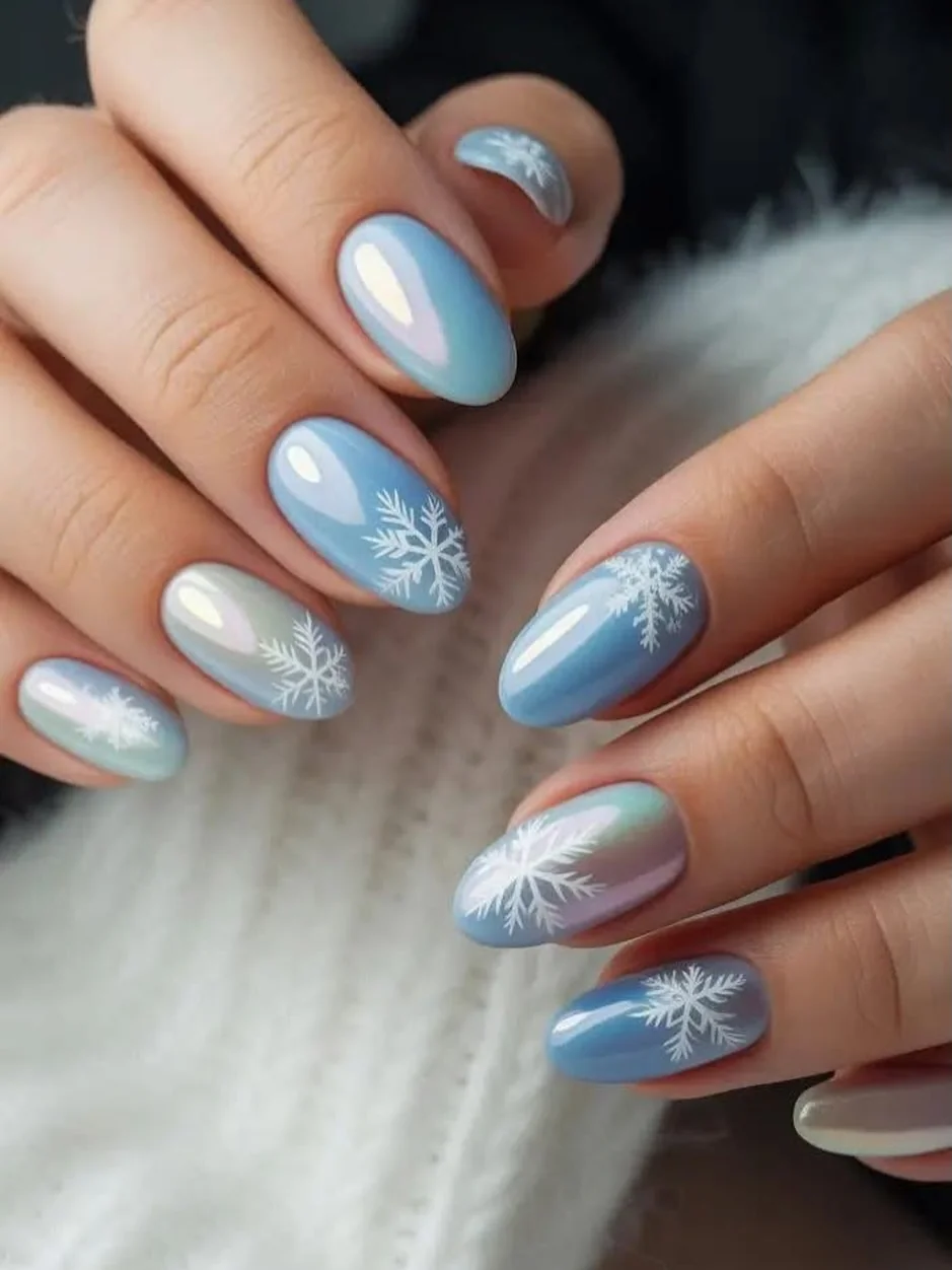 Icy blue chrome almond nails with white snowflake art