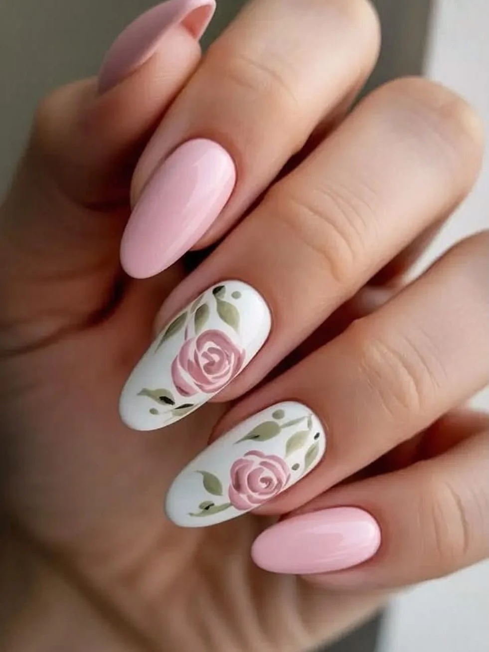Pink almond nails with white accent nails painted with 3D rose art