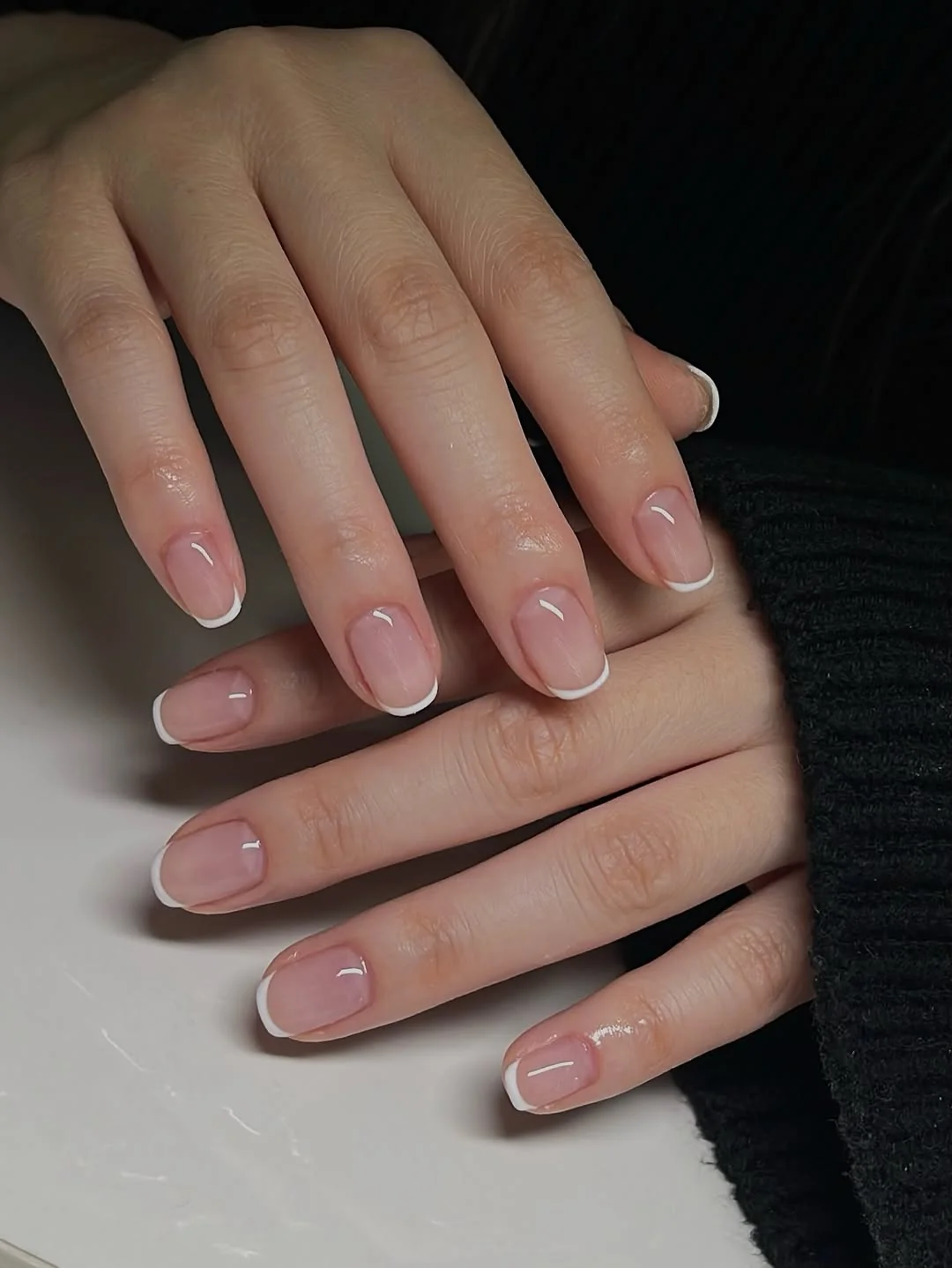 Micro white French tip short nails on a sheer nude base