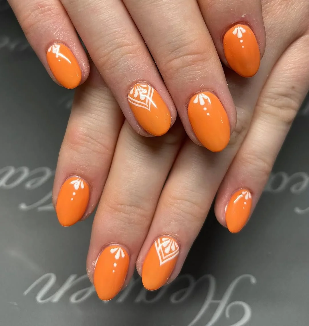 Tangerine orange short nails with white geometric accent art