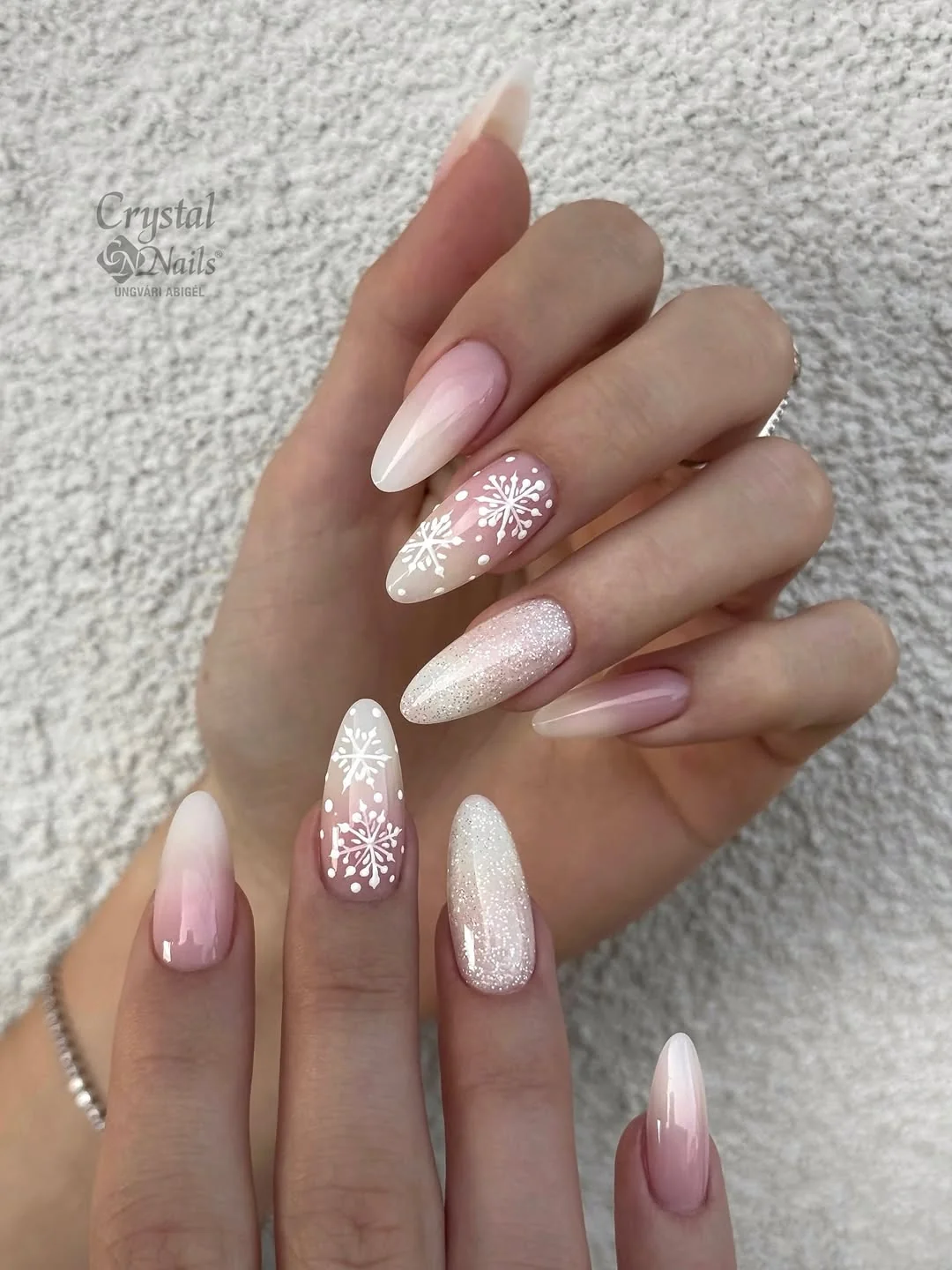 Pink to white ombré almond nails with glitter snowflake accent nails