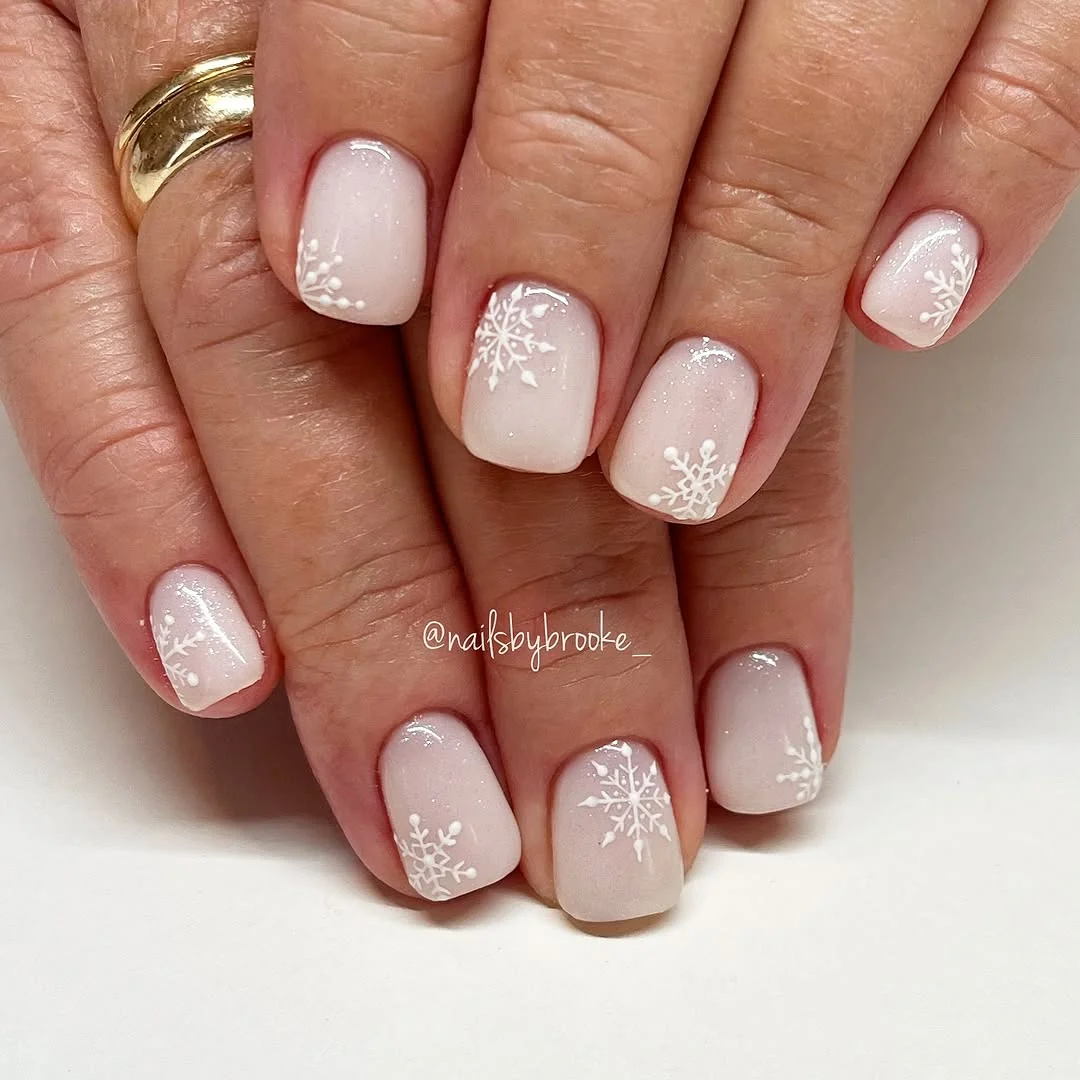 Short milky pink nails with micro white snowflakes