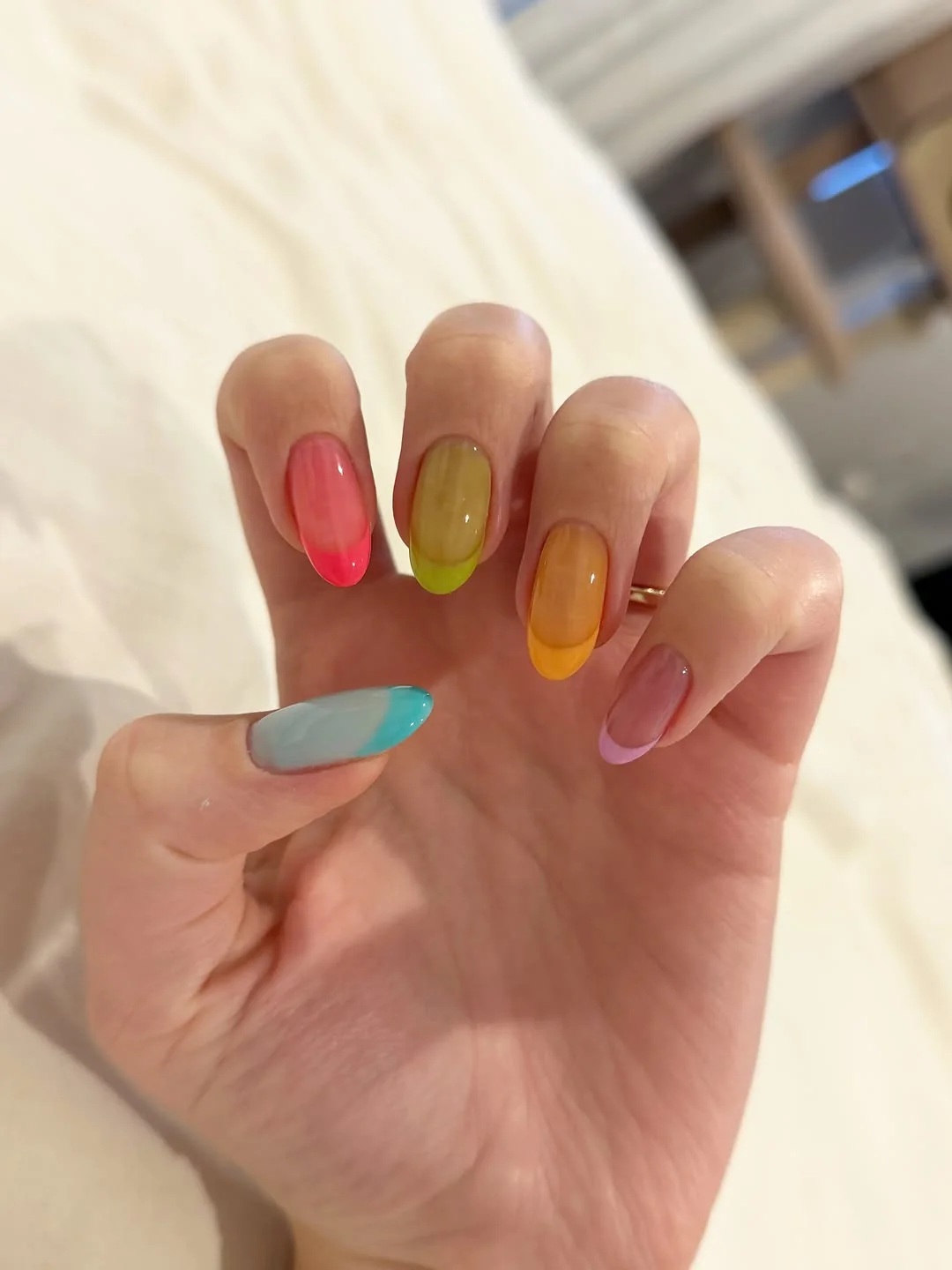 Short nails in translucent jelly pink, green, yellow and teal summer shades