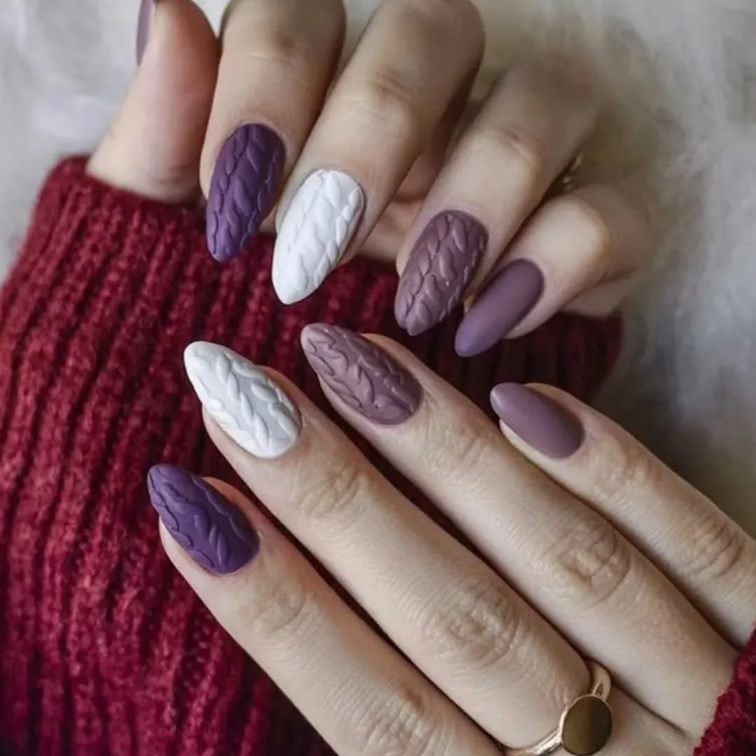 Purple, white and mauve almond nails with glossy and matte knit texture