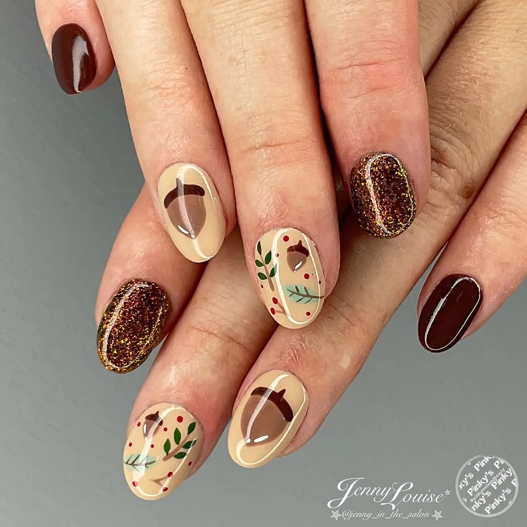 Almond nails with acorn and autumn leaf accent art in brown and nude