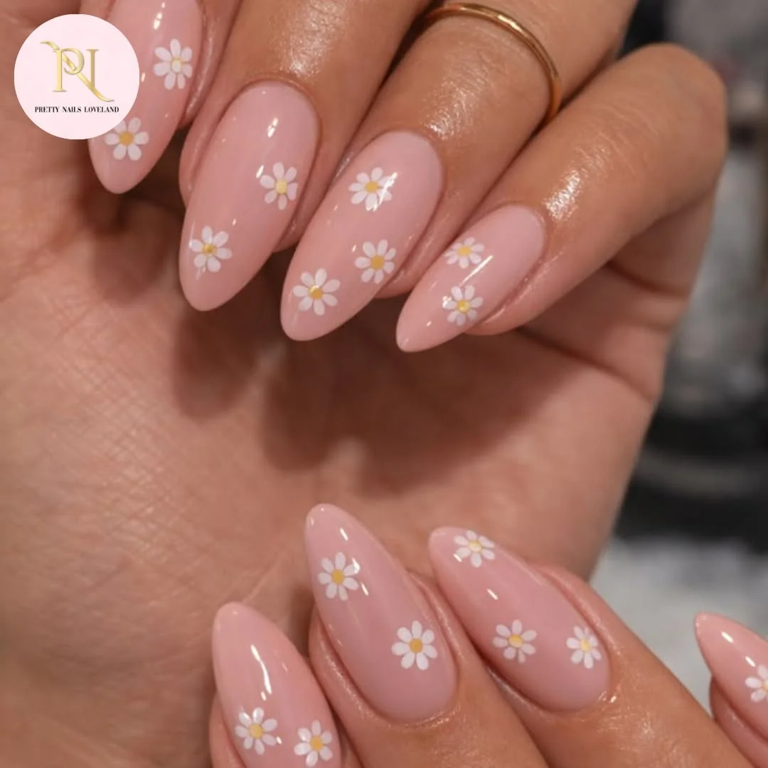 Nude almond nails with micro white daisies on each nail