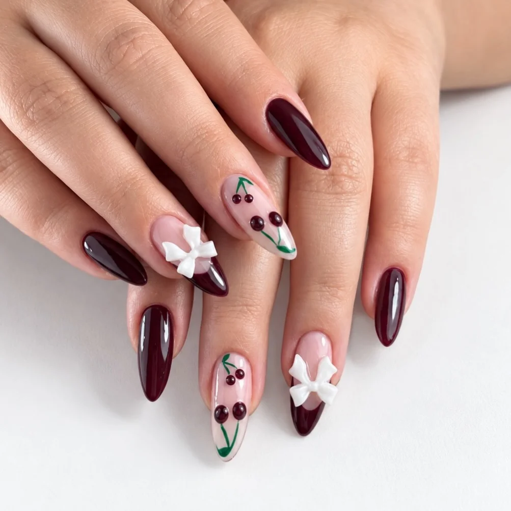 Burgundy almond nails with cherries and white coquette bows