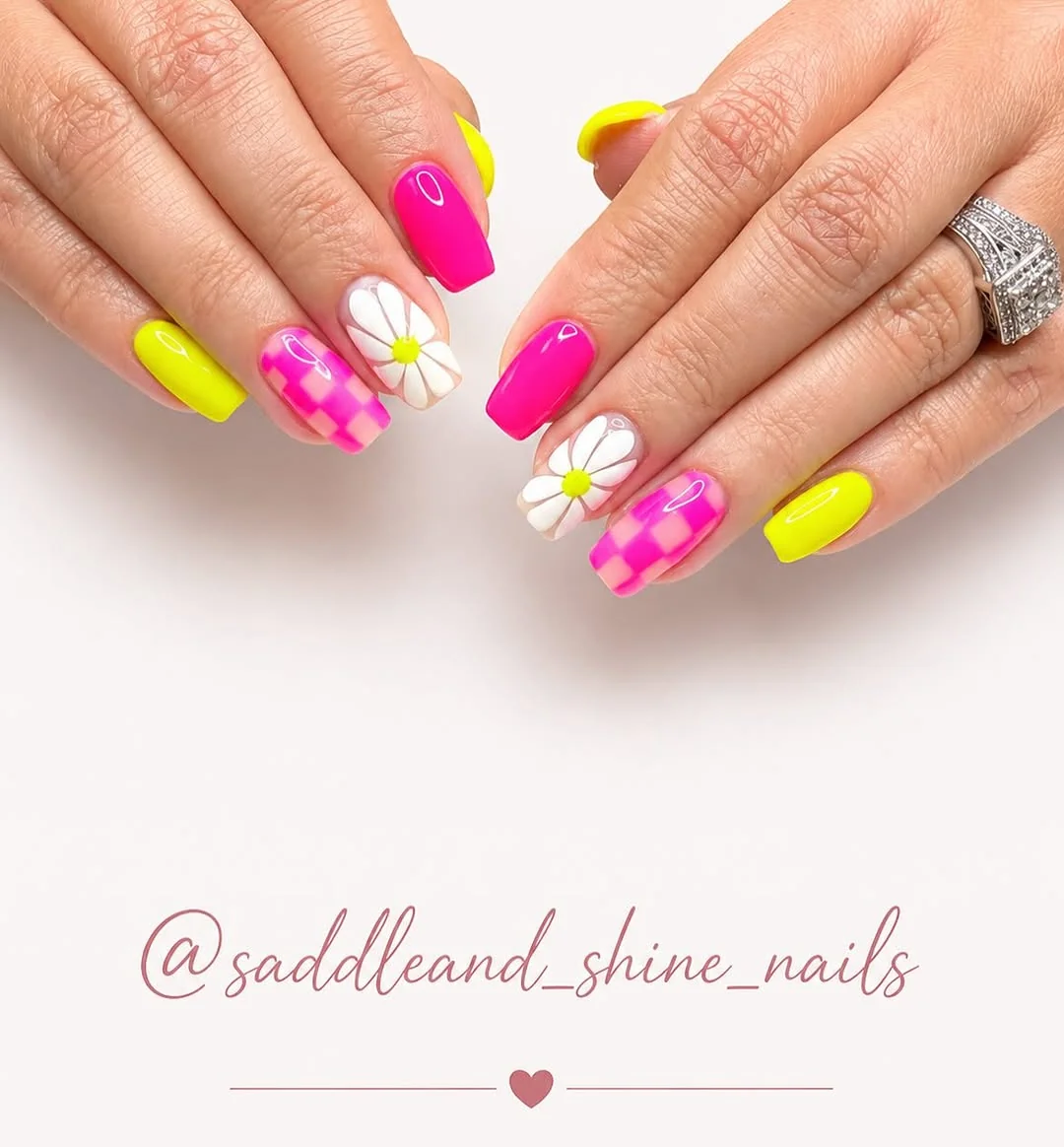 Neon yellow and hot pink nails with checkerboard and daisy accents