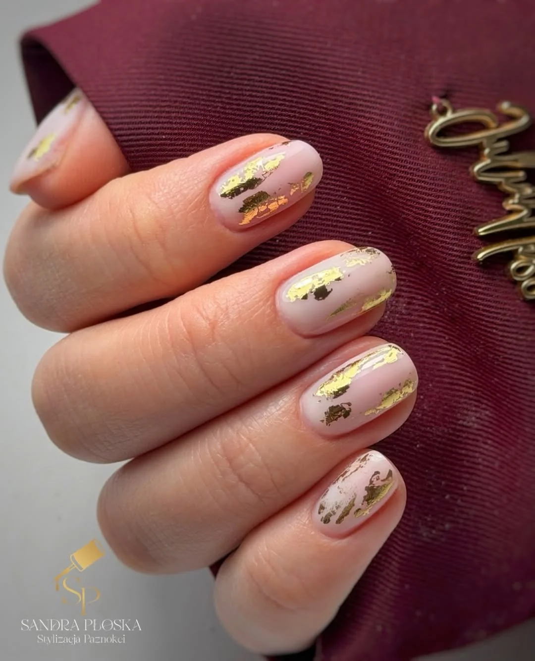 Nude almond nails with thin gold foil strips