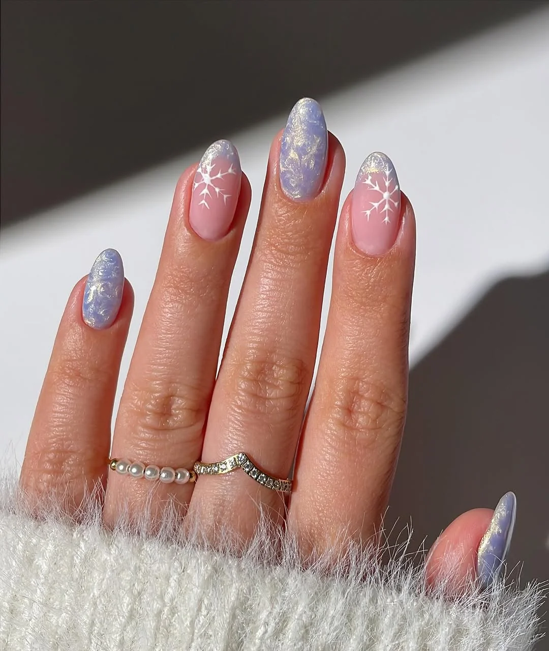 Icy blue lavender almond nails with white snowflakes and frosted swirls