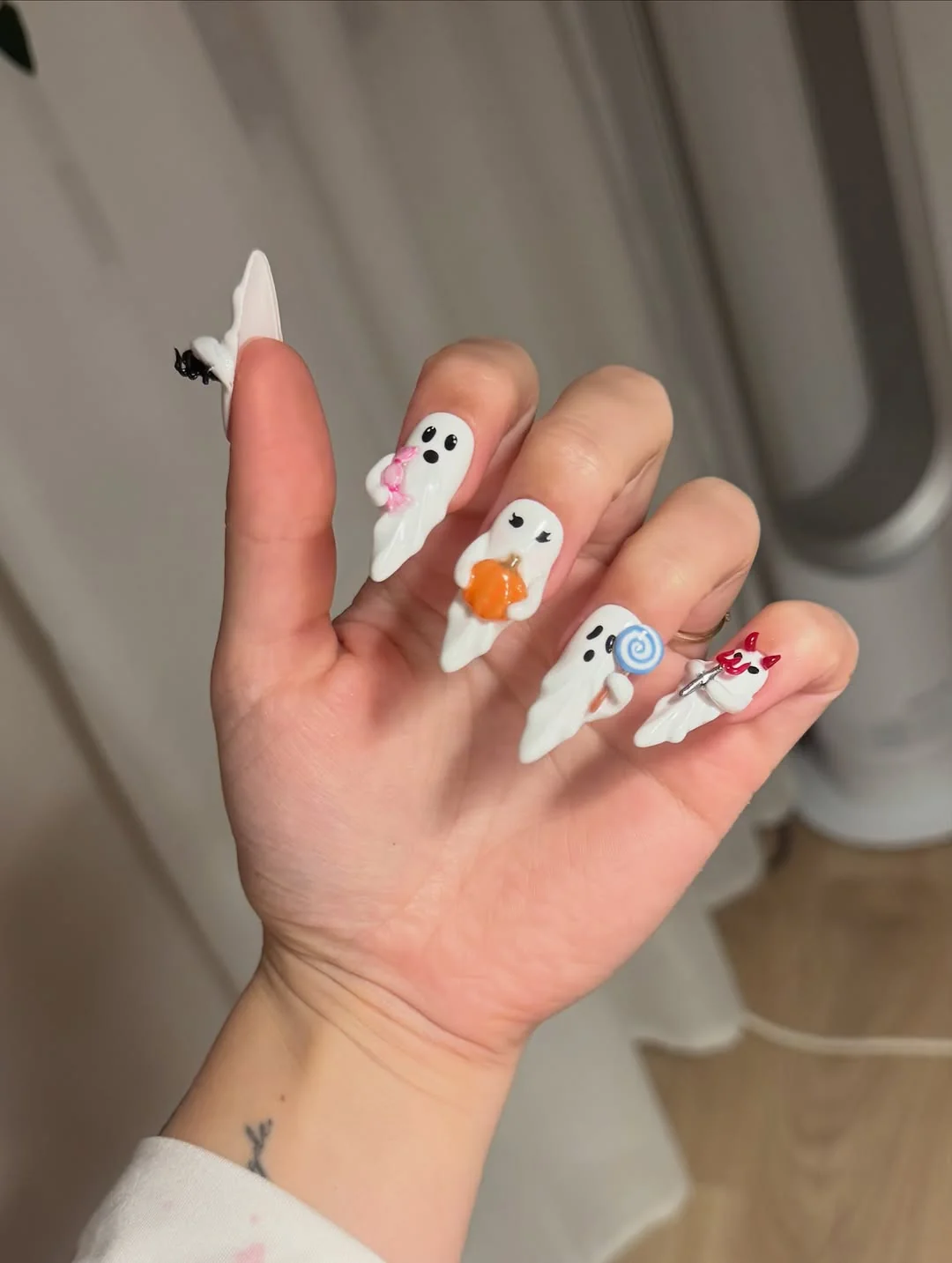 Short white nails with tiny colorful ghost nail art