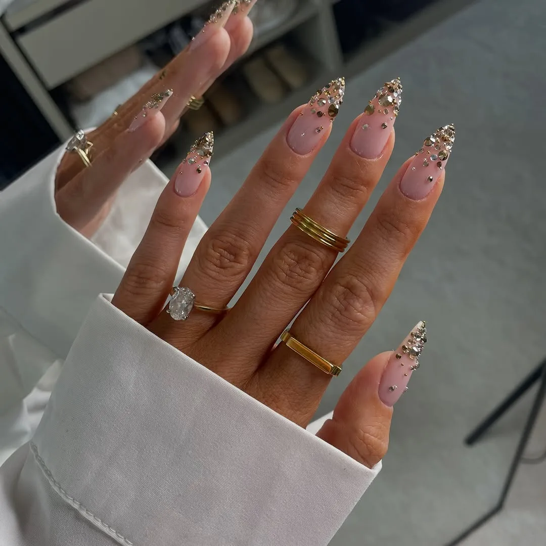 Long nude almond nails with gold French tips