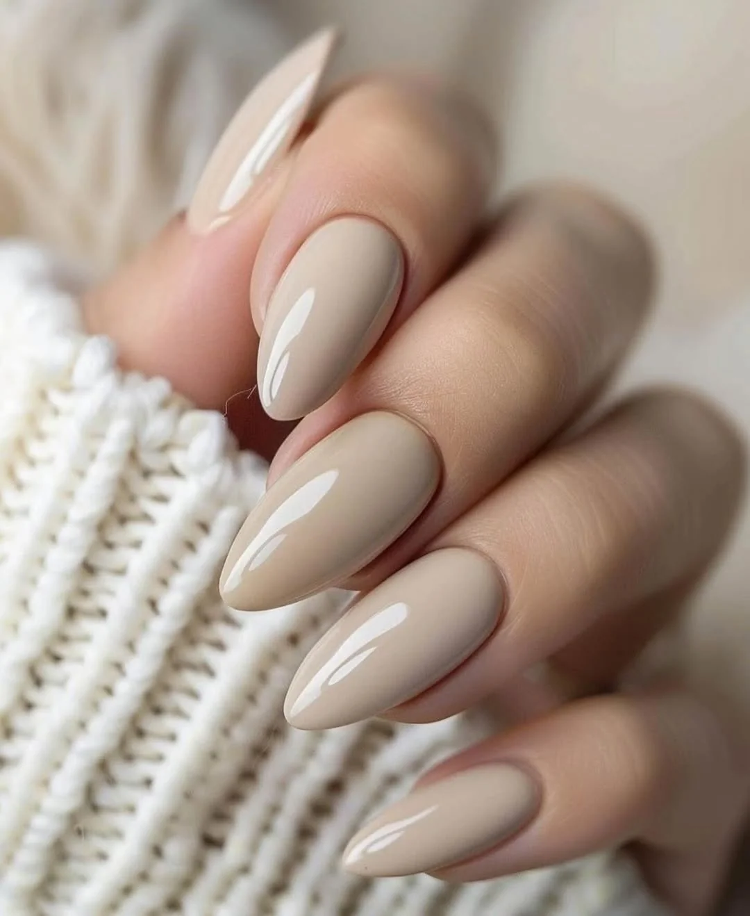 Glossy neutral taupe almond nails for an office-friendly sweater look