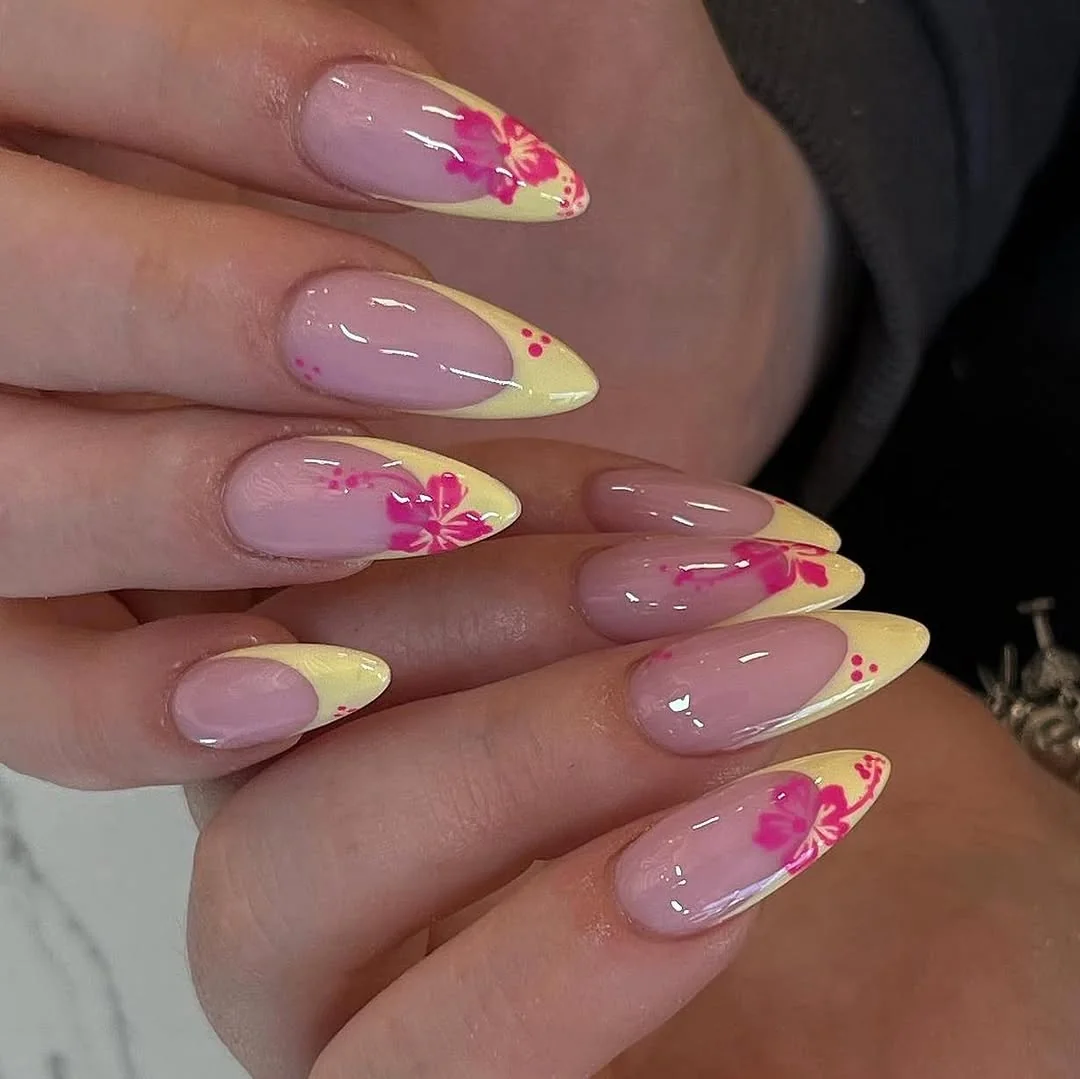 Sheer pink almond nails with pale yellow French tips and pink hibiscus flowers