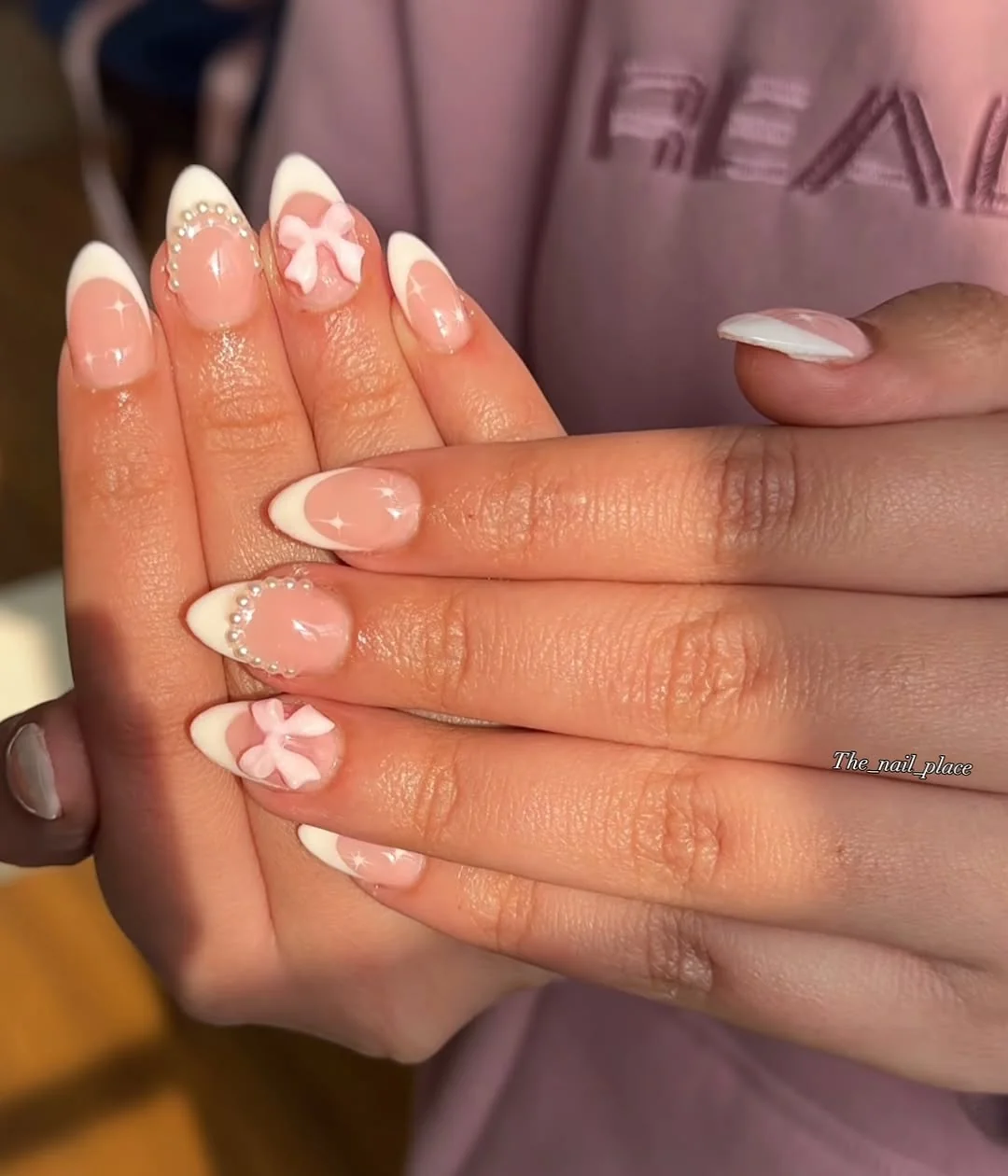 White French tip almond nails with pink bow accent nails