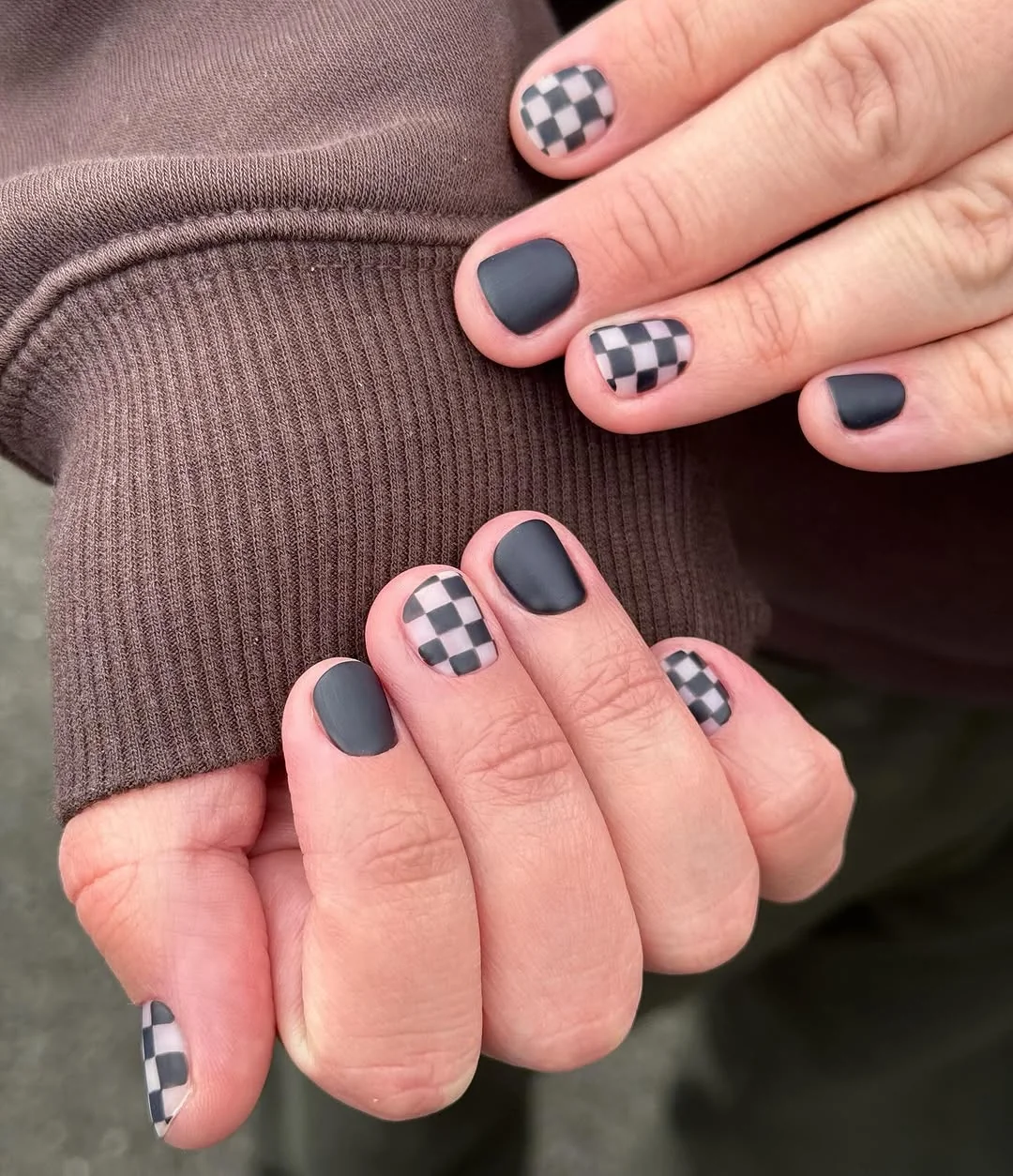 Short matte gray men's nails with checkerboard accent nails