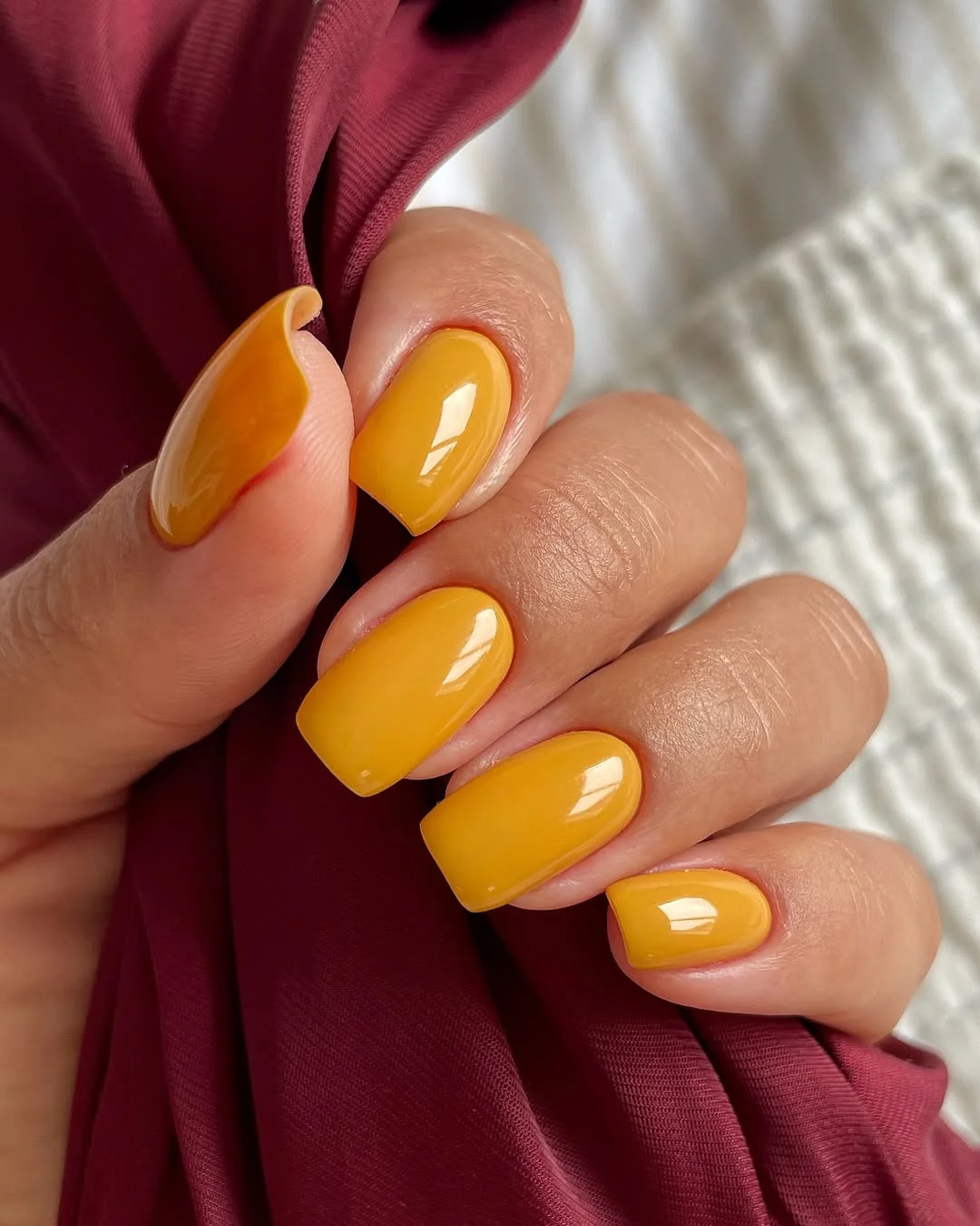 Mustard yellow short square nails with a glossy finish