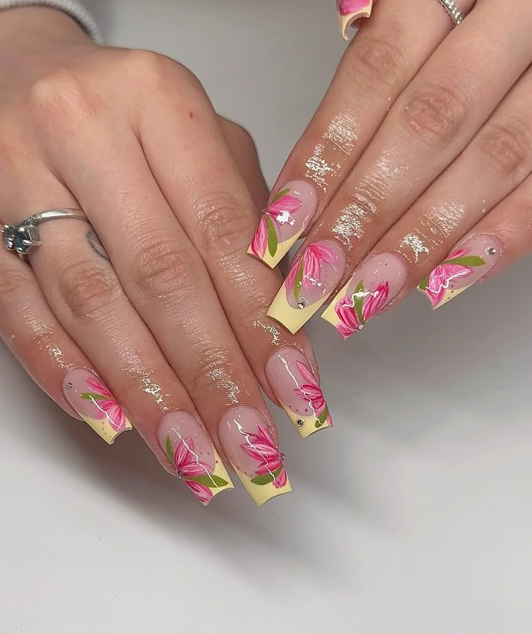 Coffin nails with pink flowers and yellow French tips