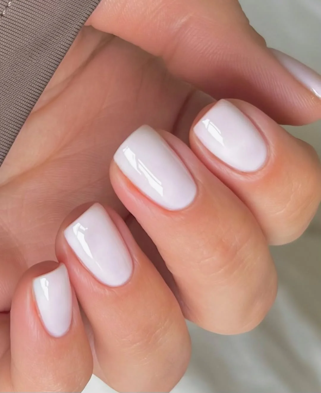 Short milky white square nails with a glossy finish