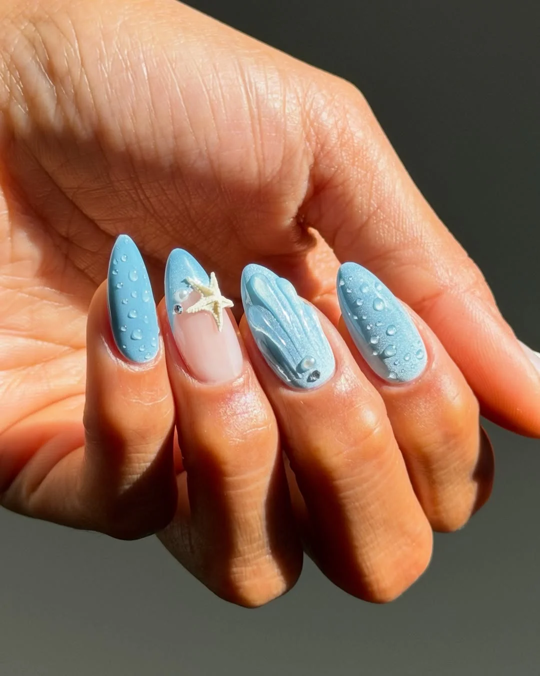 Light blue almond nails with starfish and seashell beach art