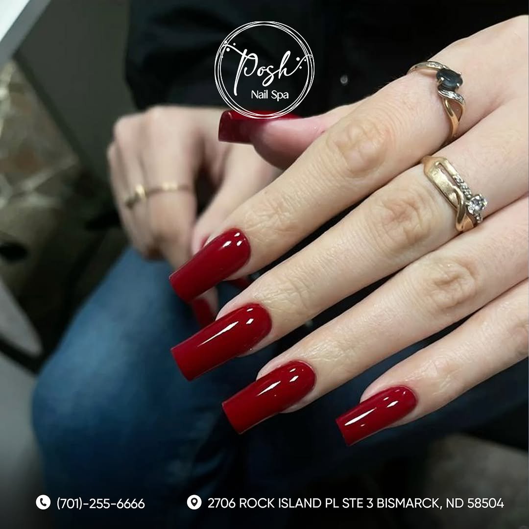 Short bright cherry red nails with a glossy finish