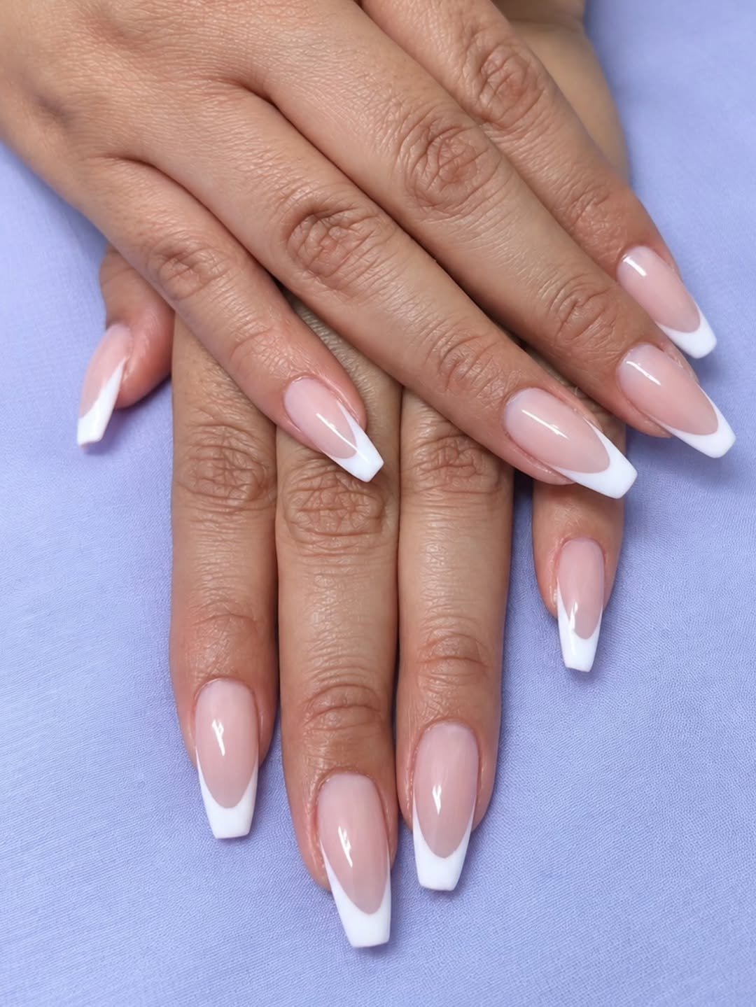 Coffin nails with a sheer pink base and classic white French tips