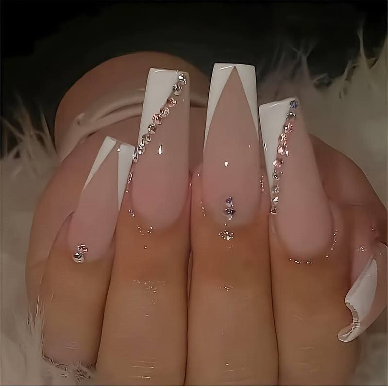 Long coffin nails with V-shaped white French tips and tiny rhinestones